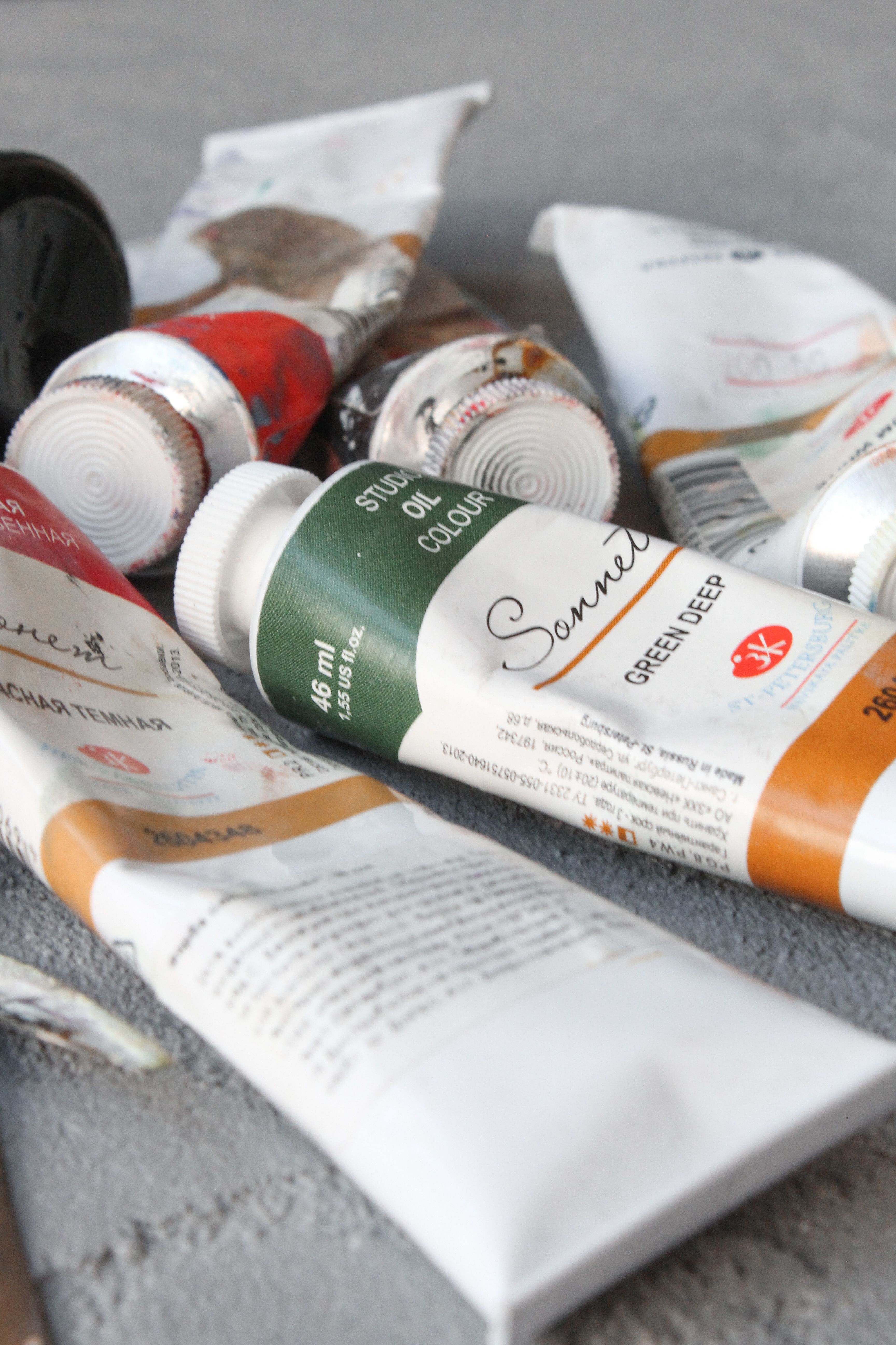Assorted oil paint tubes arranged on a table surface, ideal for art and creativity concepts.