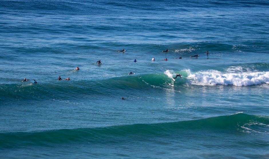 Surfers catching waves in a vibrant ocean scene, perfect for summer vacation themes.