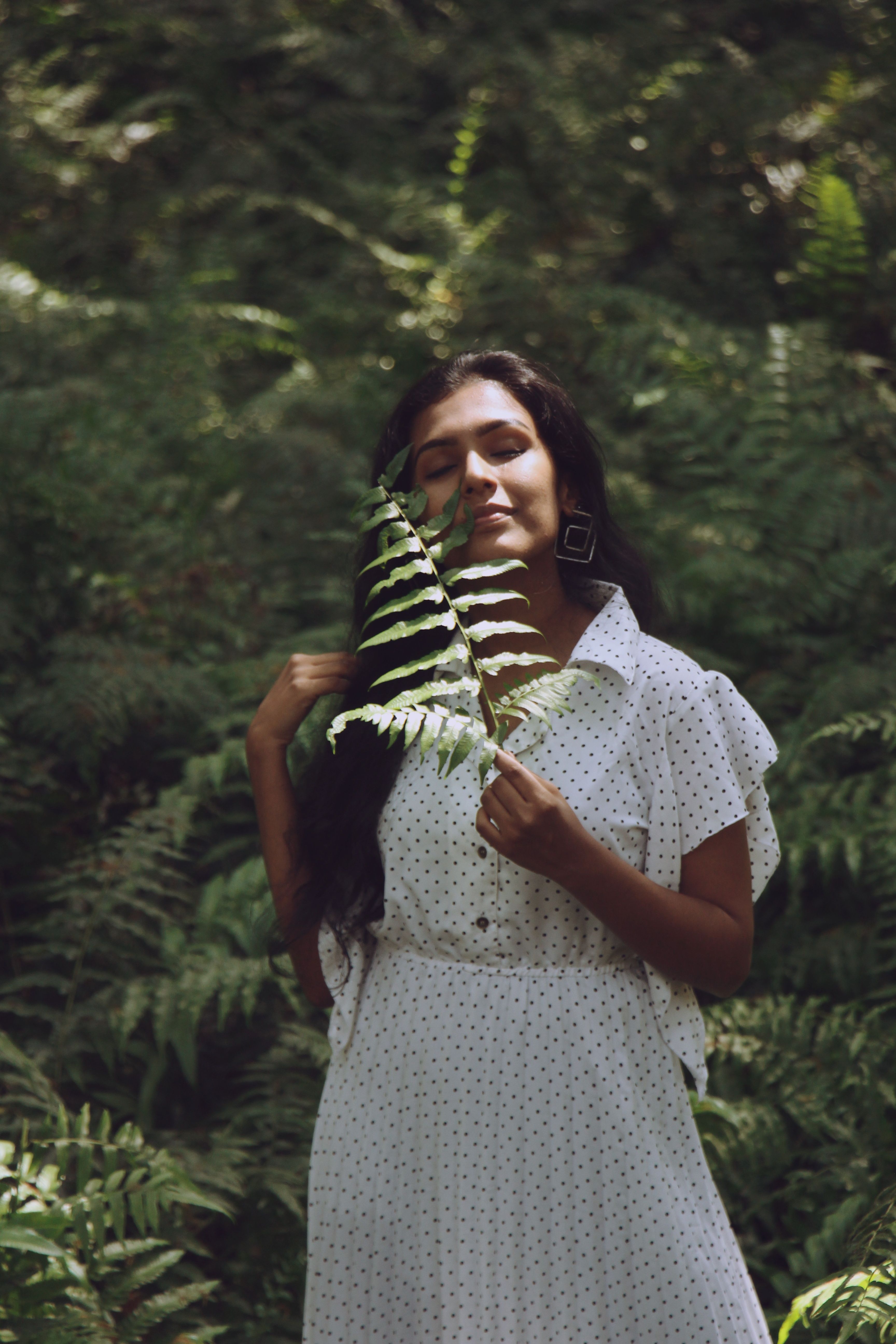 Woman in Polka Dot Dress Holding Green Fern Leaves · Free Stock Photo