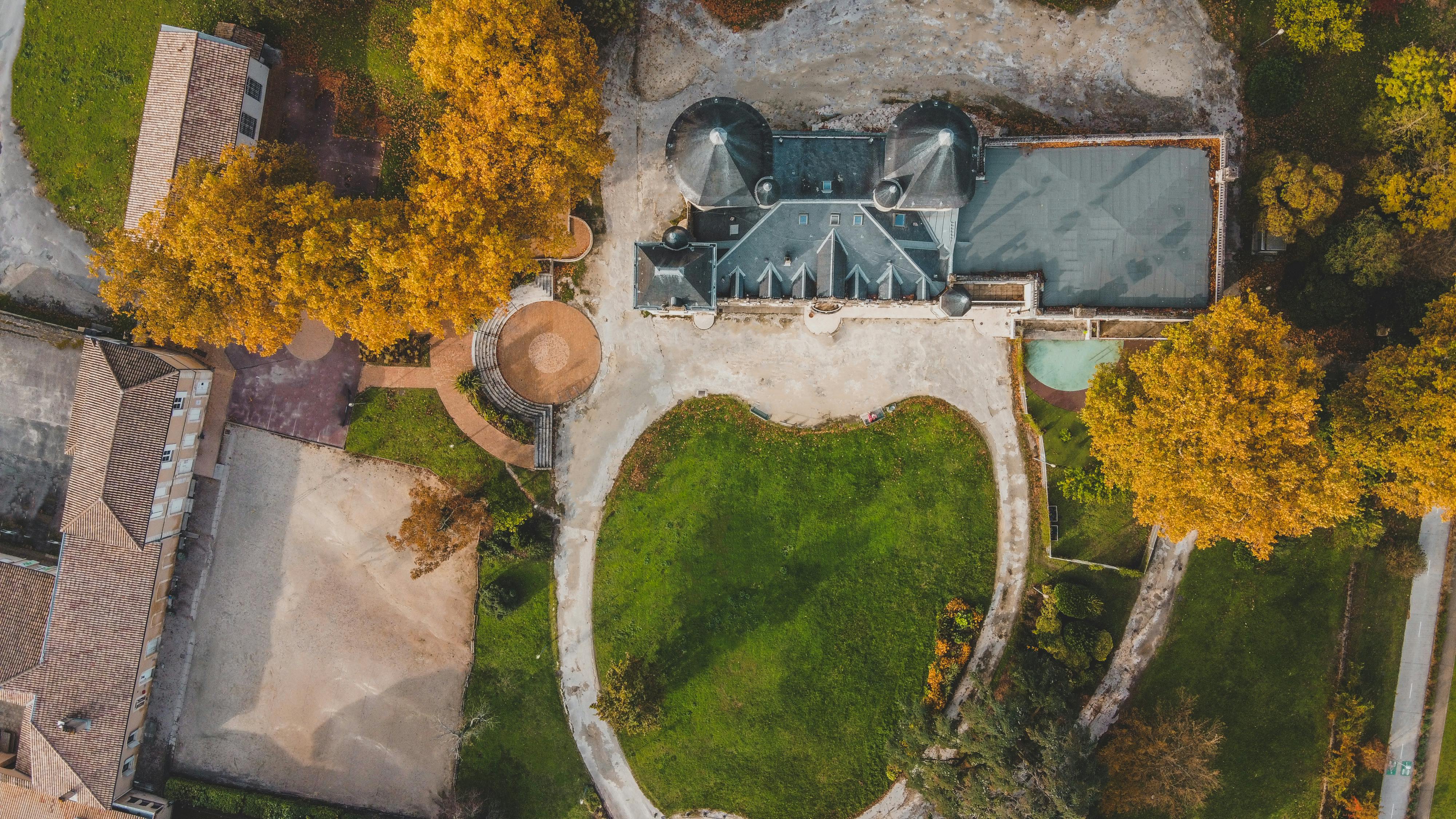 aerial view of green trees and gray concrete building