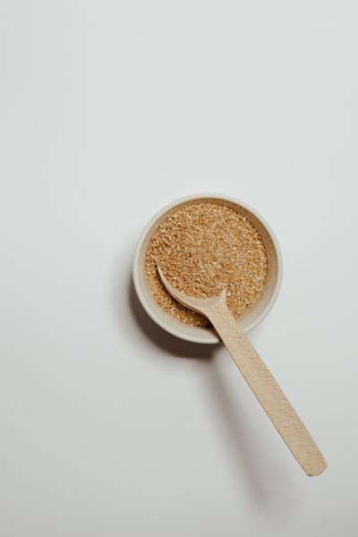 Dark brown sugar in a bowl with a wooden spoon. Photo by Vie Studio on Pexels.