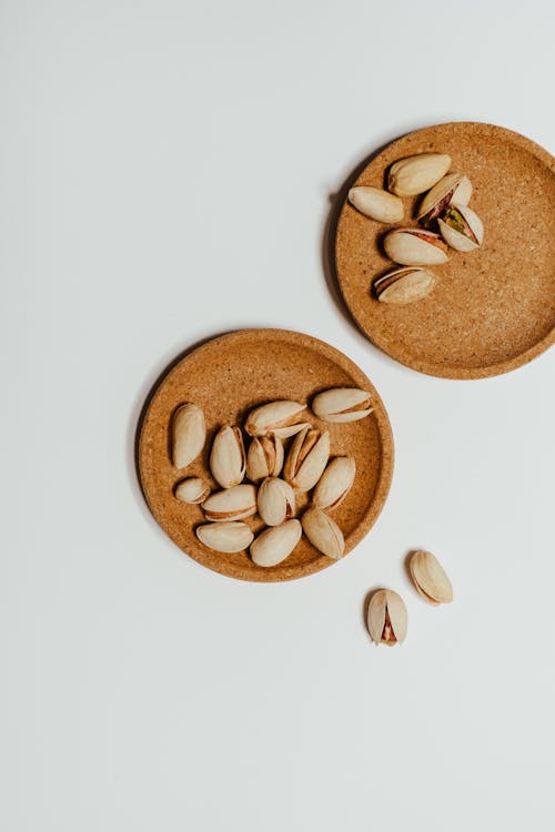Free Pistachios on Brown Cork Coaters Stock Photo