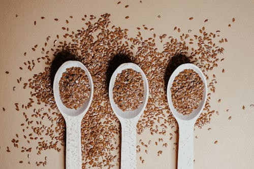 Free Three Wooden Spoons with Flax Seeds Stock Photo