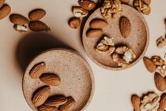 High angle view of organic almonds and walnuts on beige background. Perfect for healthy lifestyle themes.
