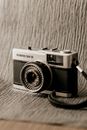 Old photo camera with lens and inscription