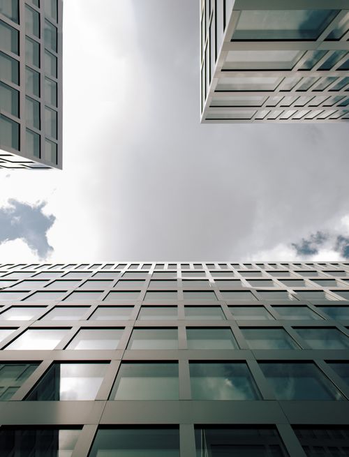 Free Low-angle view of sleek, modern skyscrapers in Zürich, showcasing architectural design. Stock Photo