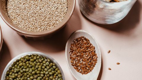 A flat lay of various nuts and seeds, showcasing natural and organic ingredients for healthy cooking.