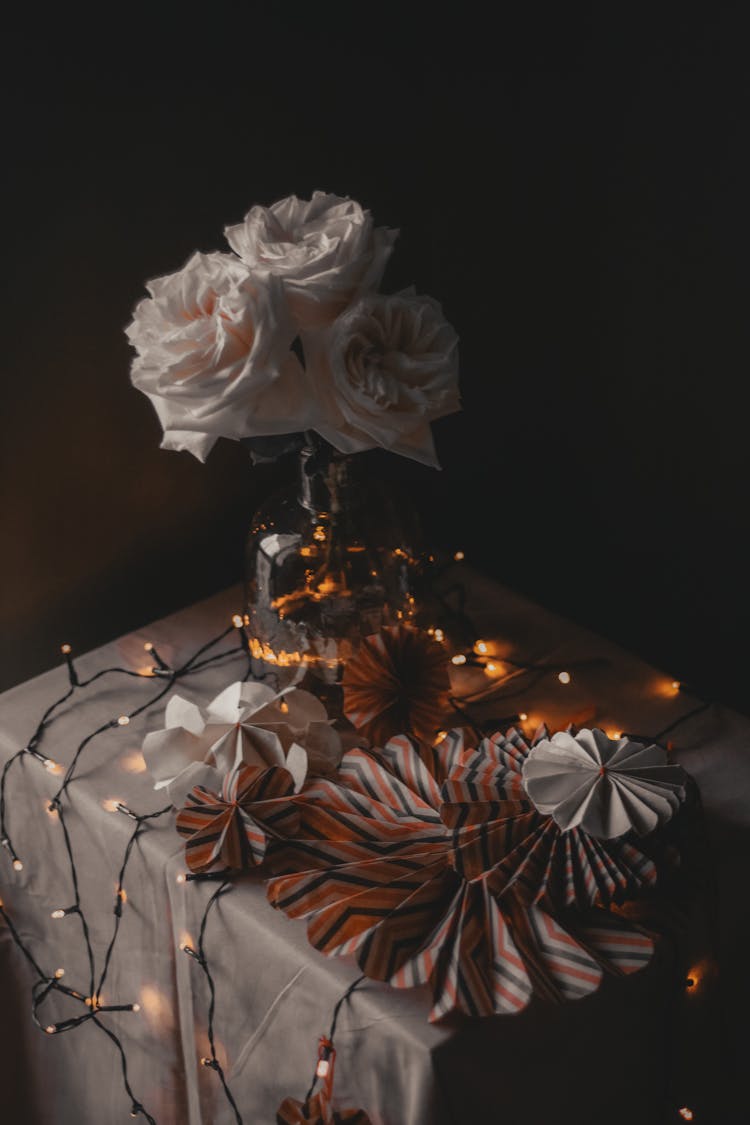 Vase With Paper Decorations On Table