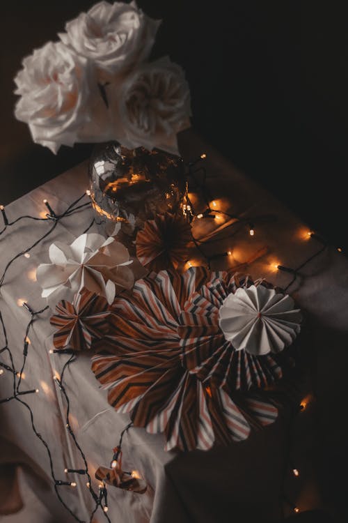 Paper decorations with garland on table
