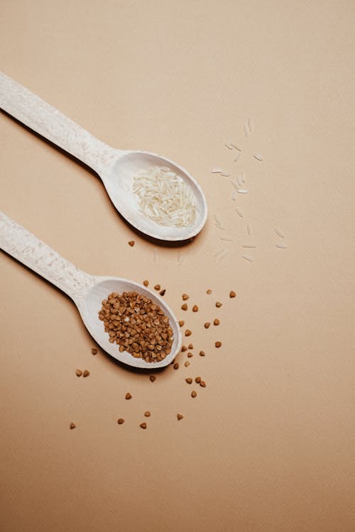 Buckwheat and Rice Grains on Spoons