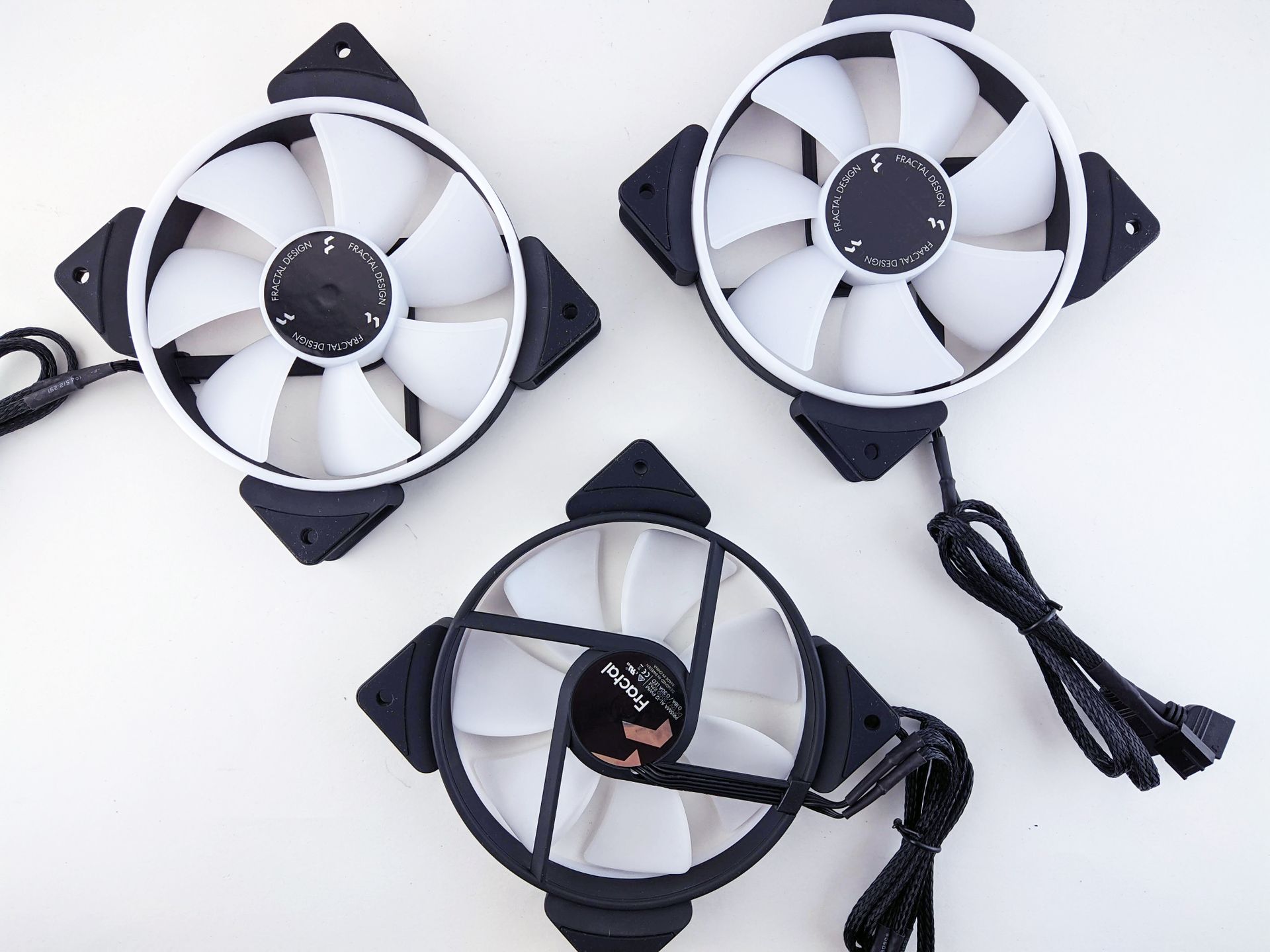Top-down view of three high-performance computer cooling fans with black casing and connectors.