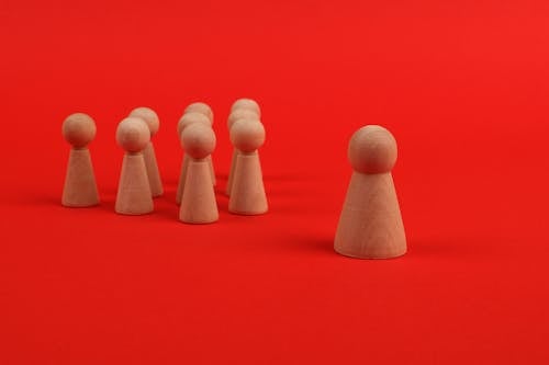 Wooden Figures on the Red Background