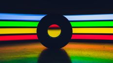 Disk against colorful spectrum lights
