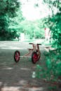 A Toy Tricycle on the Concrete Pavement in the Park