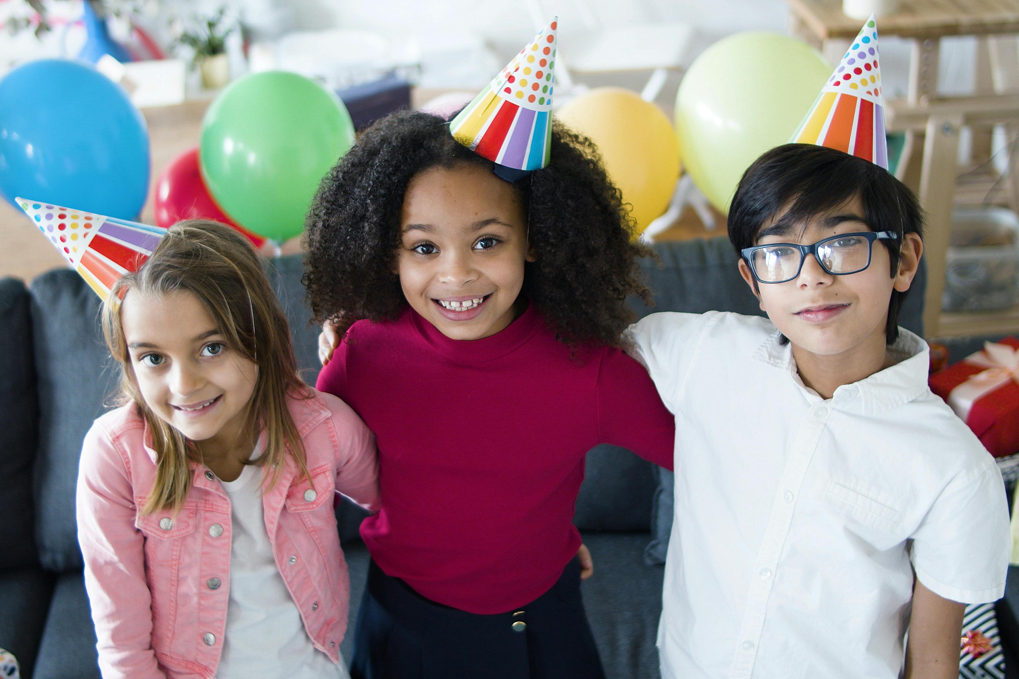 kids wearing birthday cones