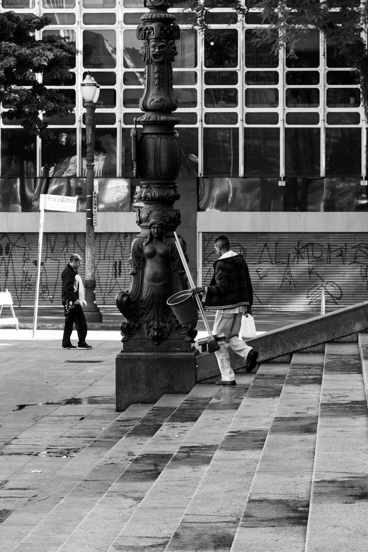 A Man Carrying Cleaning Materials