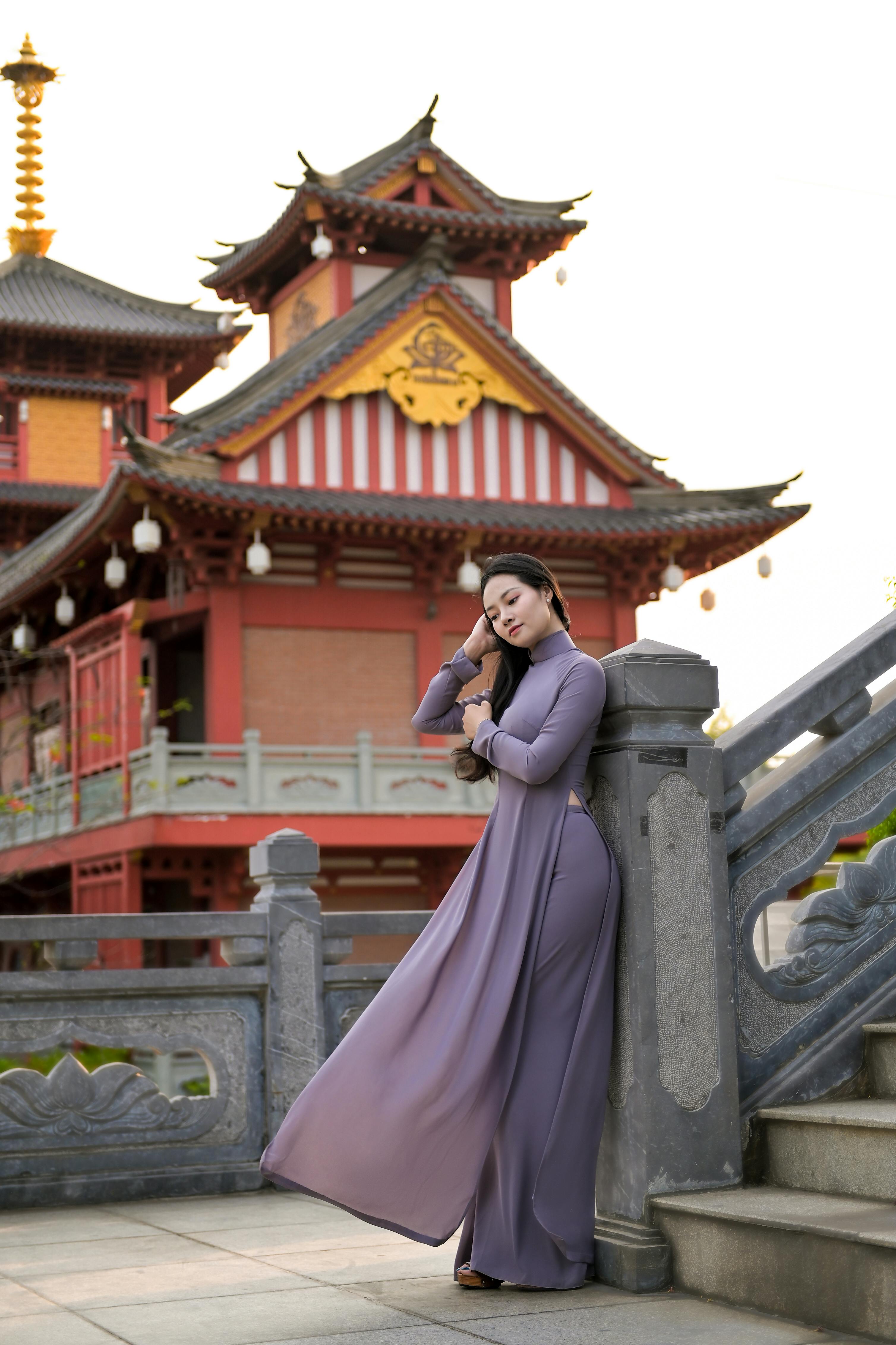 woman wearing traditional outfit leaning on a railing