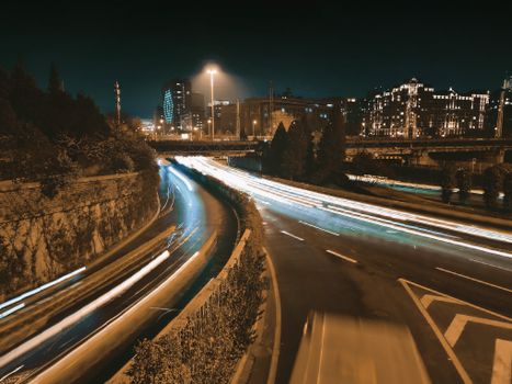 Captivating long-exposure cityscape of Beijing with illuminated streets and skyscrapers.