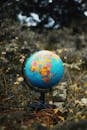 Earth globe toy placed on grass in park