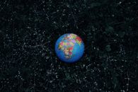 Earth globe placed on dark grass