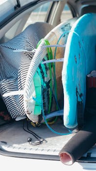 Surfboards packed in a car trunk, prepared for a watersport adventure.