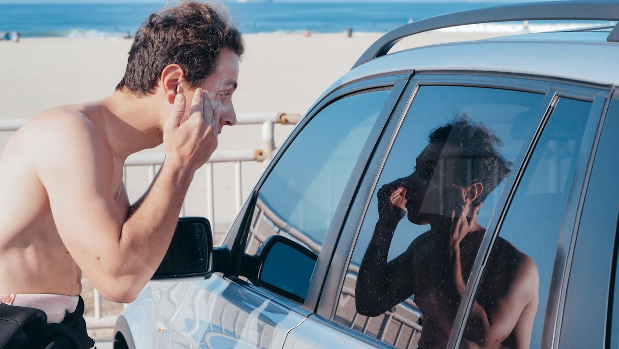 Free Man in White T-shirt Sitting on Car Stock Photo