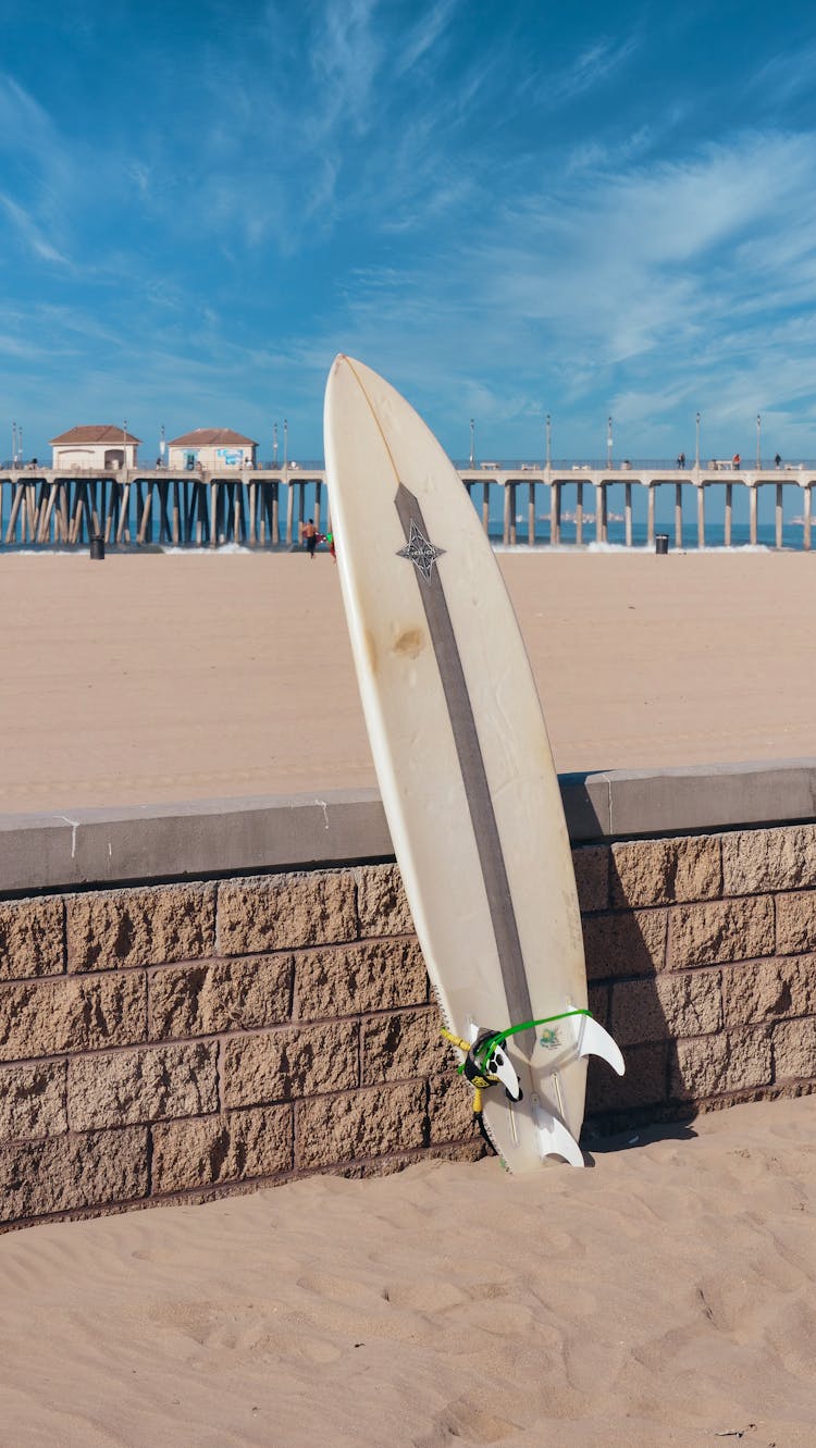 A Surfboard On A Brick Fence