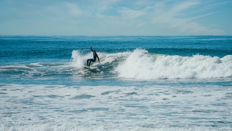 A Surfer Riding The Sea Waves