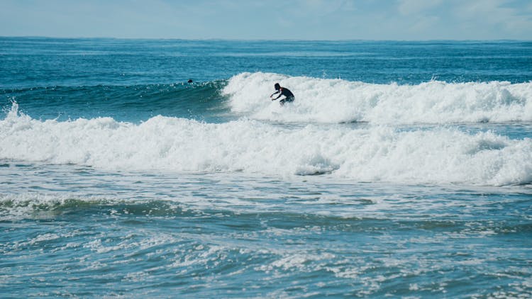 A Surfer Riding The Sea Waves