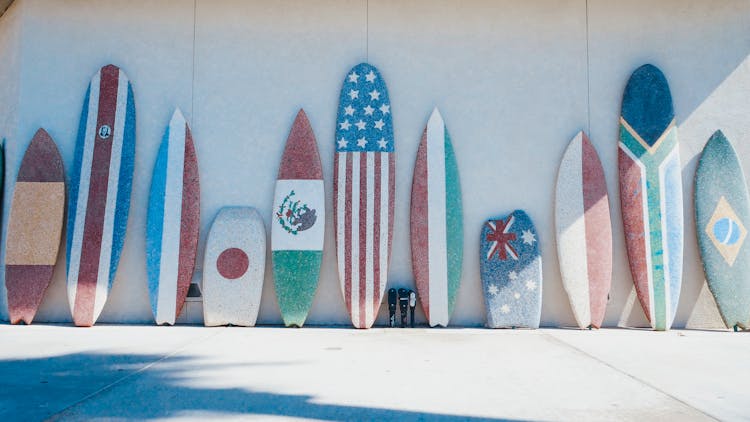 Surfboards With Flag Designs Leaning On The Wall