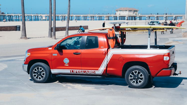 Red Pickup Truck Parked Near The Beach