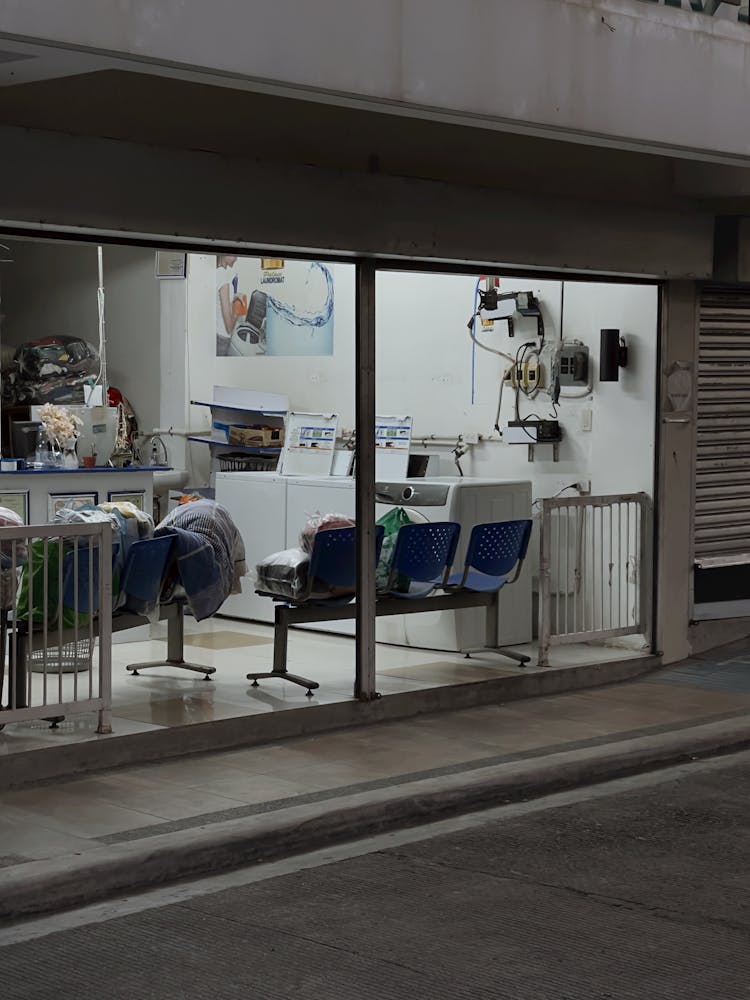 Empty Blue Seats In The Laundry Shop