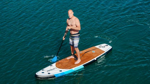 A Topless Paddleboarder in the Sea