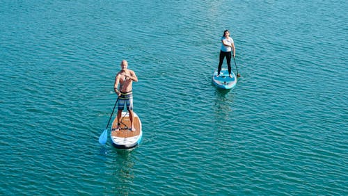 A Man and a Woman on Paddleboards