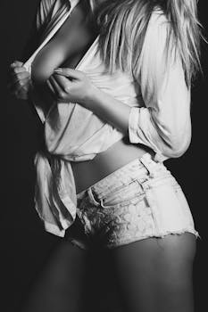 Black and white portrait featuring a stylish woman in an elegant pose, highlighting fashion and style.