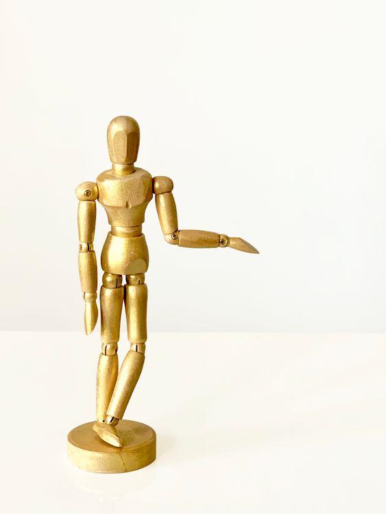Close-Up Shot of a Wooden Human Figurine · Free Stock Photo