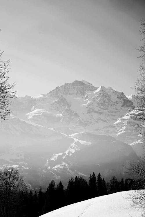 Grayscale Photo of a Snow-Covered Mountain