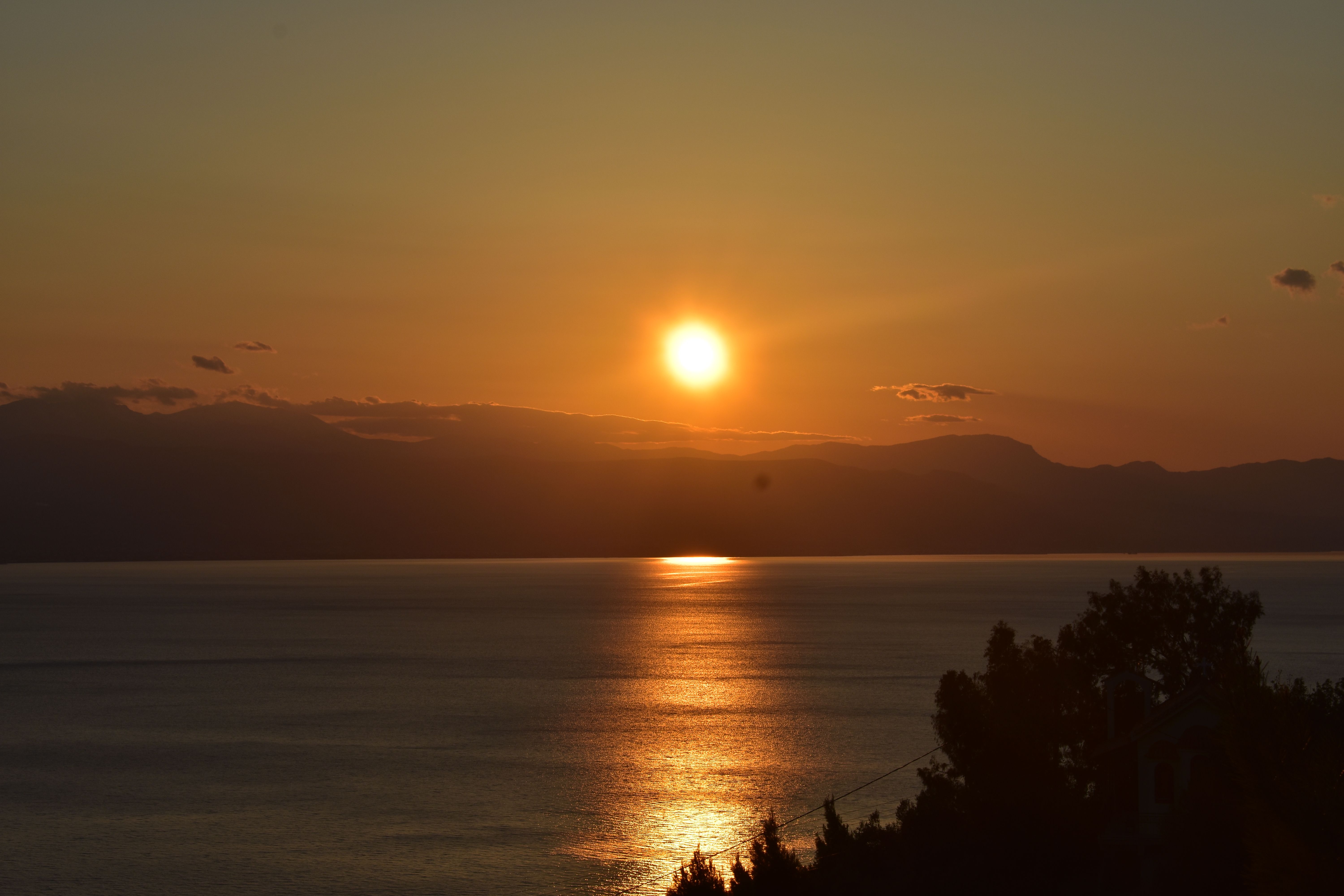 Mountains Near Sea During Sunset · Free Stock Photo