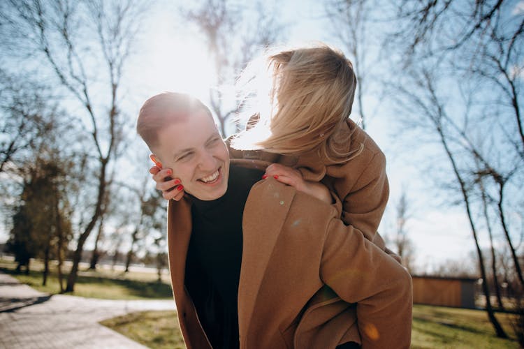 A Man Carrying A Woman On His Back