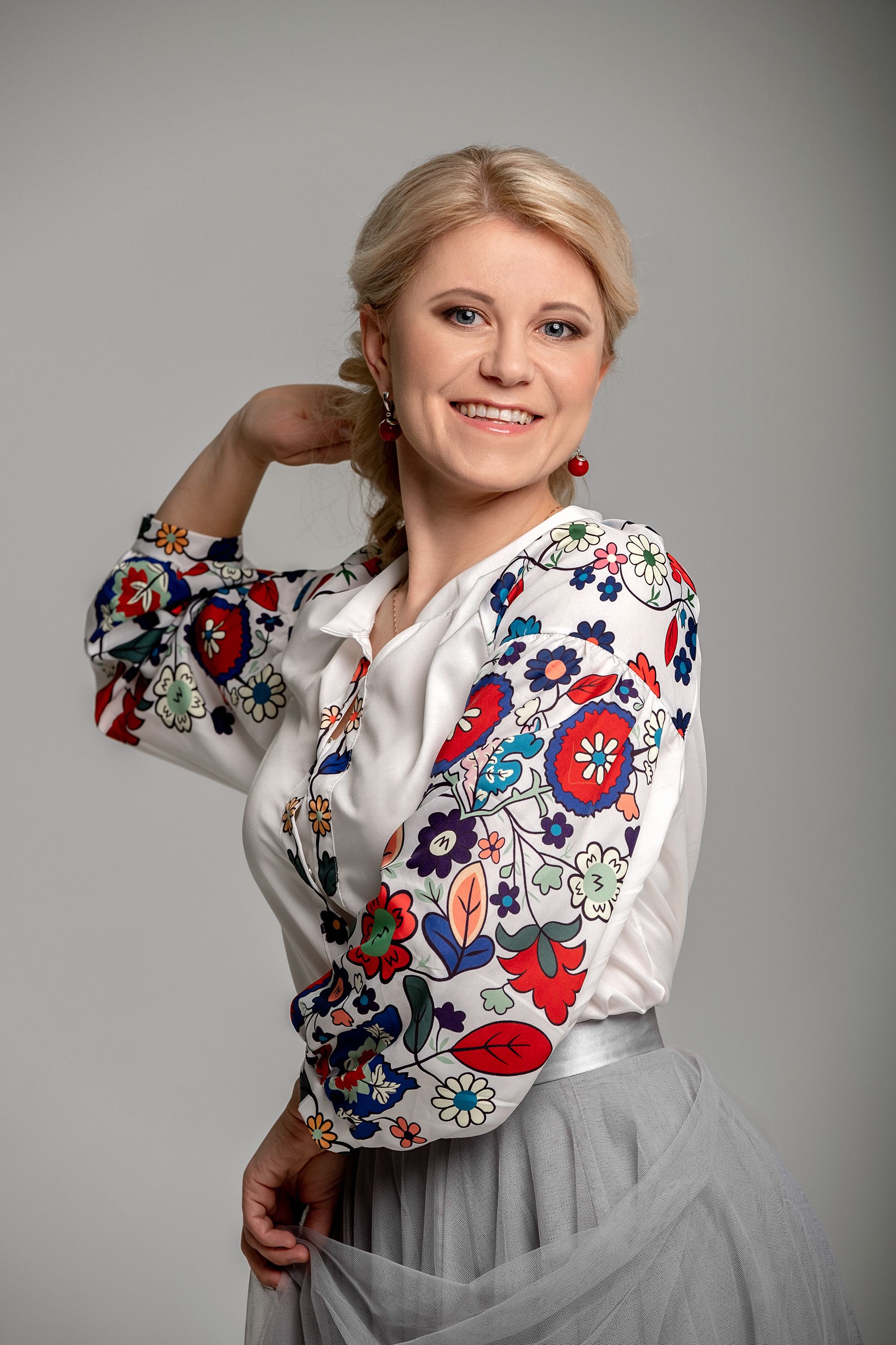 A Beautiful Woman in a Floral Top Posing and Holding Her Skirt · Free ...