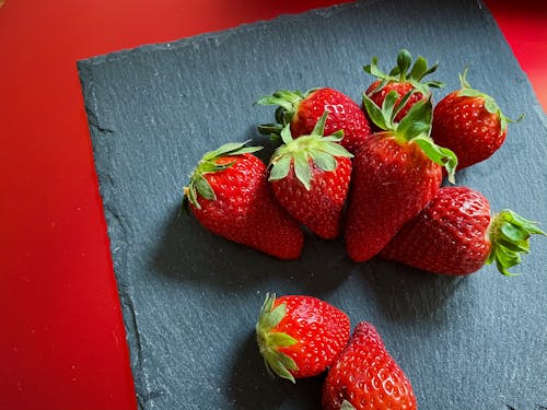 Close-Up Photo of Red Strawberries on a Gray Surface