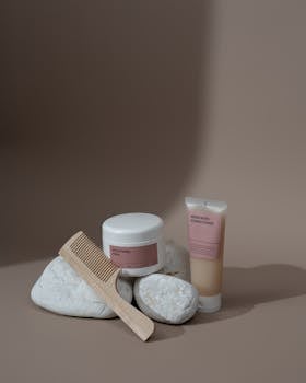 Minimalist composition featuring beauty products and a comb for a serene aesthetic.