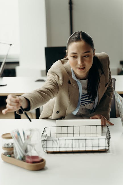 Asian businesswoman planning a project in a modern workplace environment.