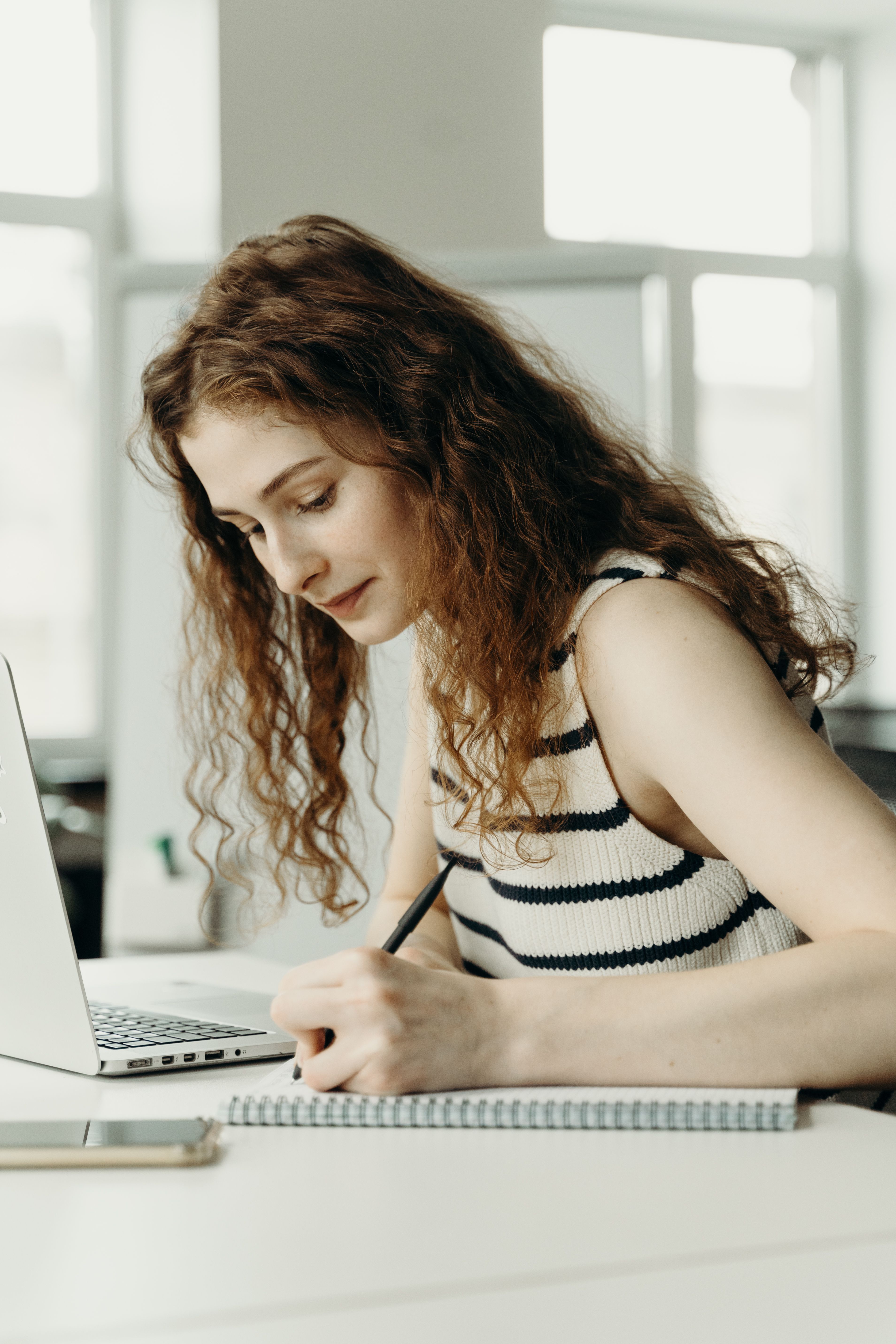 Woman in Black and White Stripe Top Writing · Free Stock Photo