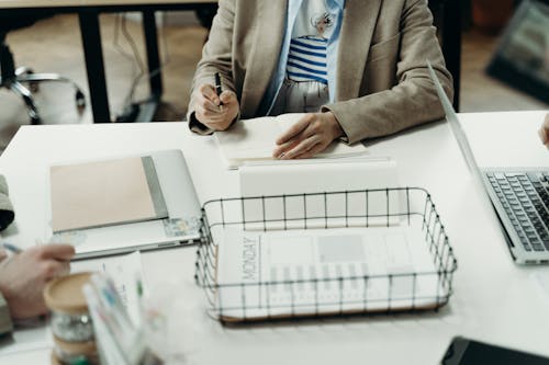 Free Person in Brown Blazer Holding a Pen Stock Photo