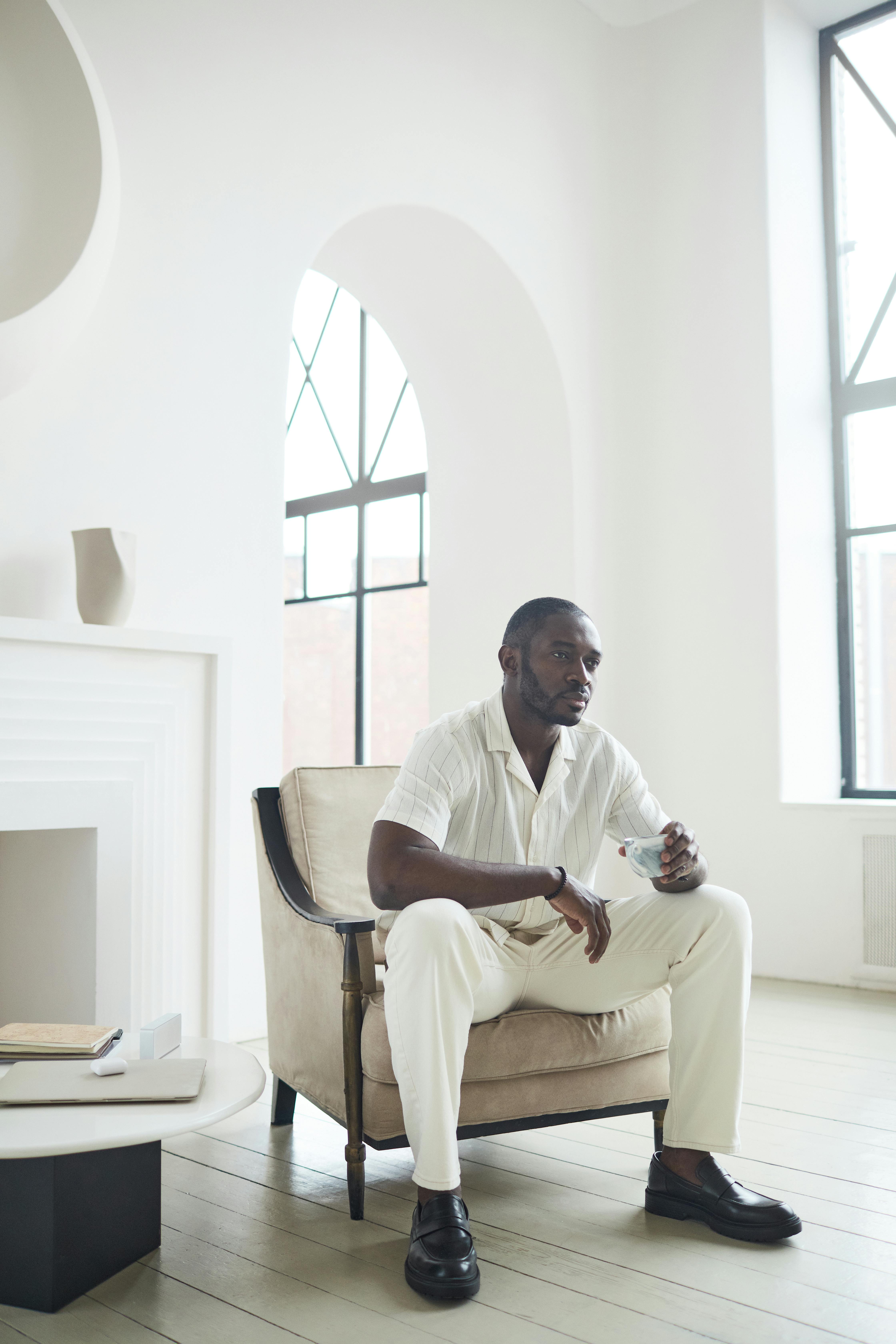 A Man Drinking Wine While Sitting in an Armchair · Free Stock Photo