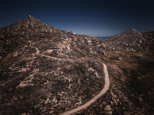 Aerial View of Dirt Road Near the Mountain
