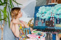 Woman painting on canvas with paints