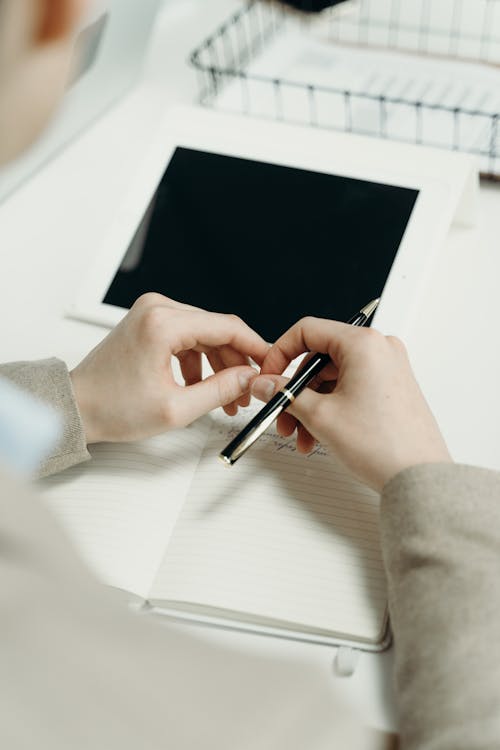 Free Person Holding a Pen Stock Photo