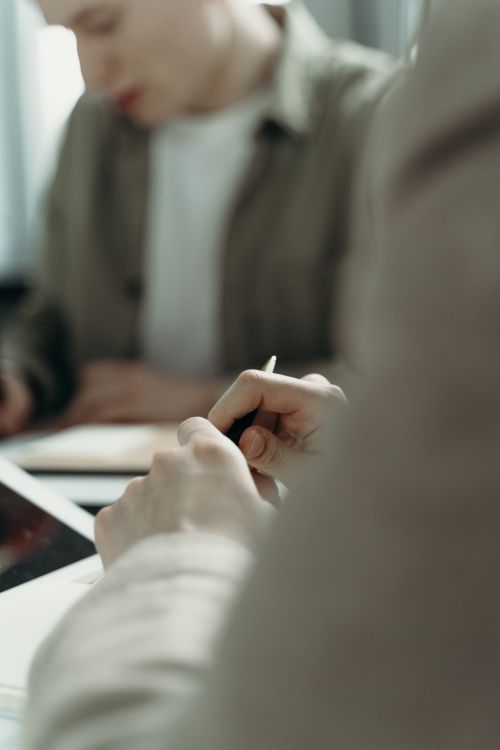 Person Holding a Pen · Free Stock Photo